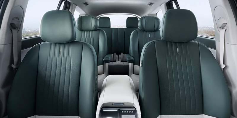 An interior view of a 2026 Hyundai IONIQ 9 with green leather seats and a central console.