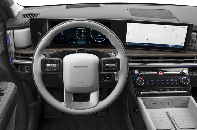 A modern 2026 Hyundai Santa Fe dashboard featuring a large steering wheel, dual screens, and sleek controls.